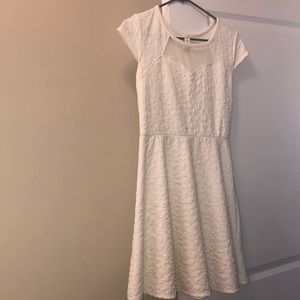 girl's form-fitting white/cream dress